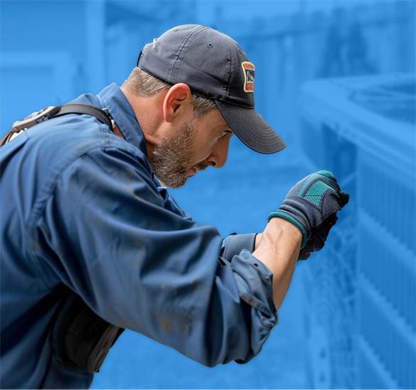 HVAC technician working on an air conditioning unit.